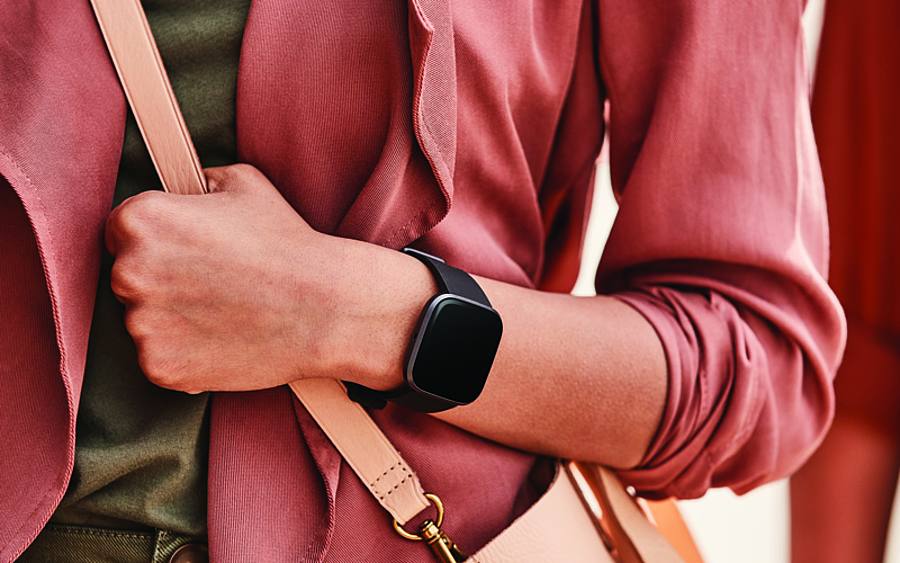 Die Fitbit Versa 2TM am Handgelenk einer jungen Frau