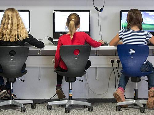 Schülerinnen arbeiten an Computern. Foto: Friso Gentsch/dpa