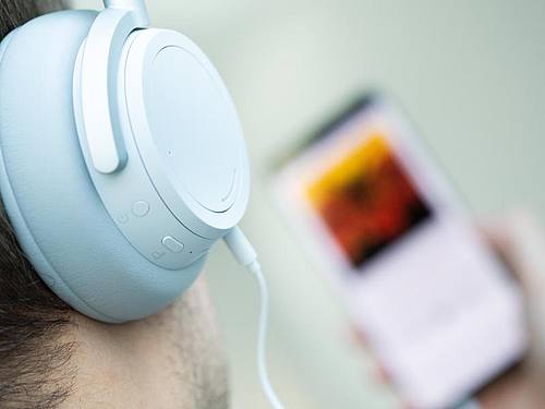 Ein junger Mann hört auf seinem Smartphone einen Podcast. Foto: Franziska Gabbert/dpa-tmn/dpa