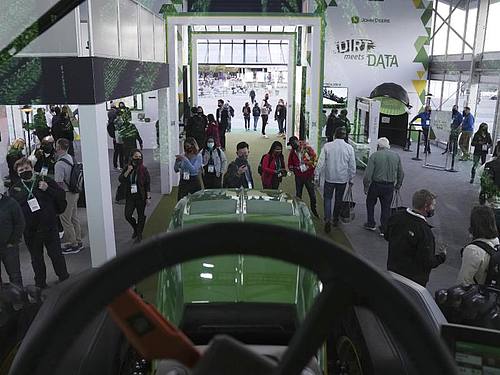 Besucher sehen sich den automatisierten Traktor von John Deere während der CES an. Foto: Joe Buglewicz/AP/dpa