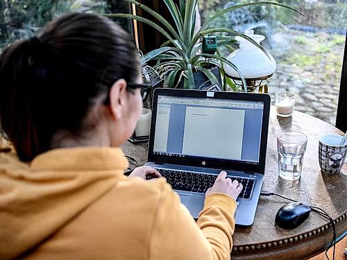 Eine junge Frau arbeitet im Homeoffice in einem Wintergarten. Der von der Corona-Krise ausgelöste Trend zum Homeoffice wird die Wirtschaft in Deutschland langfristig verändern. Foto: Britta Pedersen/dpa-Zentralbild/dpa