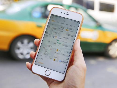 Uber und Didi hatten sich in China einen scharfen Wettbewerb mit massiven Rabatten geliefert, die für beide hohe Verluste bedeuteten. Foto: How Hwee Young