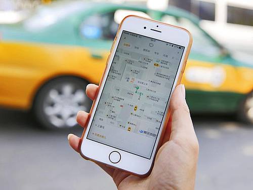 In seinem Heimatmarkt Cina setzte sich Didi in einem erbitterten Preiskampf gegen Uber durch. Foto: How Hwee Young/EPA/dpa
