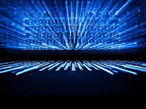 Die beleuchtete Tastatur eines Laptops spiegelt sich im Bildschirm. Foto: Silas Stein/dpa