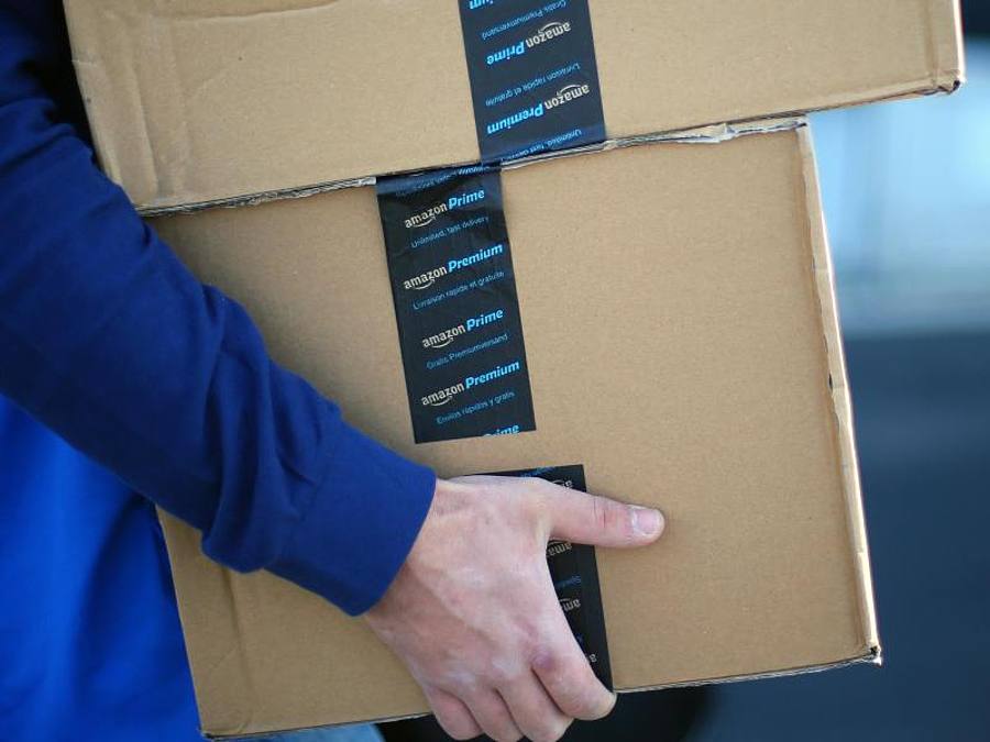 Amazon-Pakete in den Armen einen Lieferanten